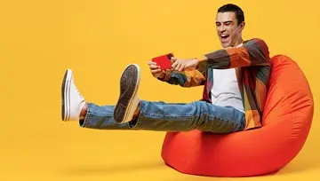 man playing a game on his mobile device  