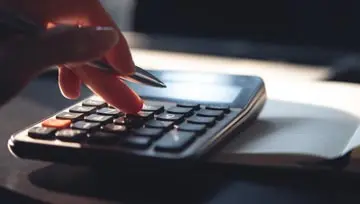 woman calculating on a calculator 