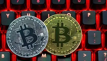 bitcoins against the background of a computer keyboard