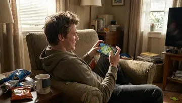 young man playing games on his phone  