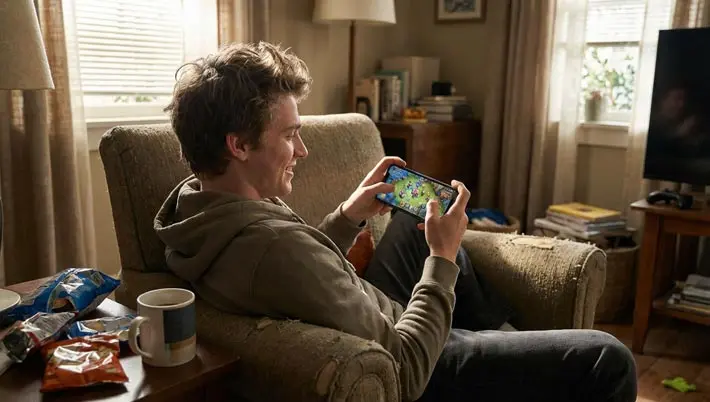young man playing games on his phone  