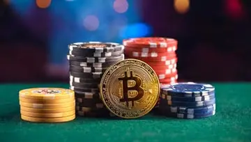 bitcoins and casino chips on a casino table