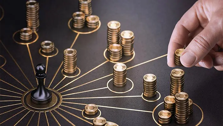stacks of gold coins in circles surrounding a gaming table wheel 