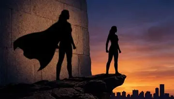 silhouette of woman and her shadow with a superhero cape