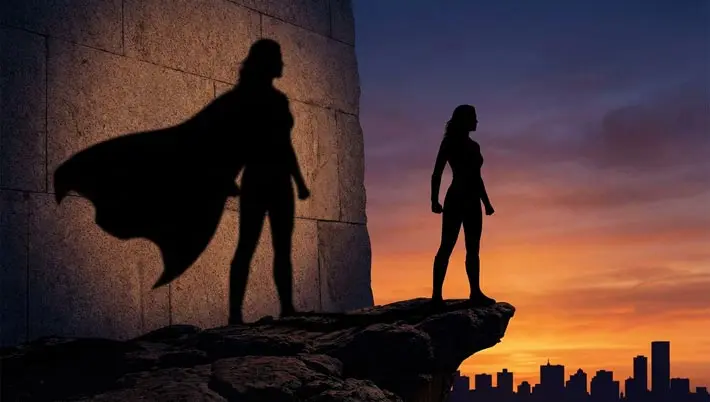 silhouette of woman and her shadow with a superhero cape