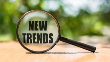 the words NEW TRENDS written on a magnifying glass