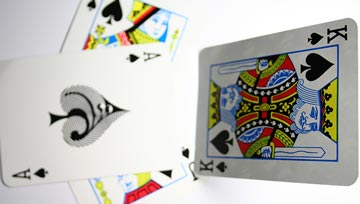 2 playing cards, one with a king and the other with a queen