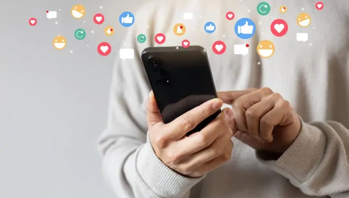 person on a mobile with social media icons