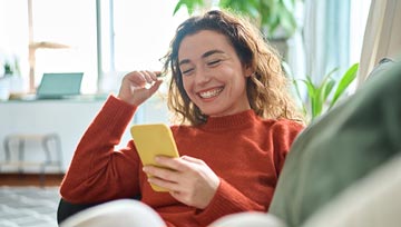 woman playing on her mobile device