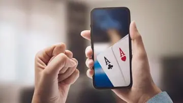 woman holding a mobile device that shows two aces