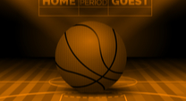 basketball sitting on a court with a Home - Guest sign behind