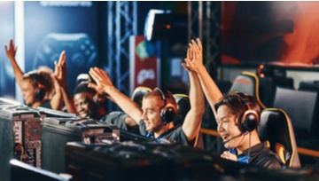 Esports team all sitting at their computers next to each other. 