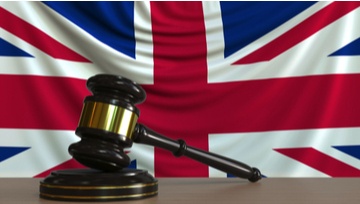 gavel on a desk with a British flag in the background