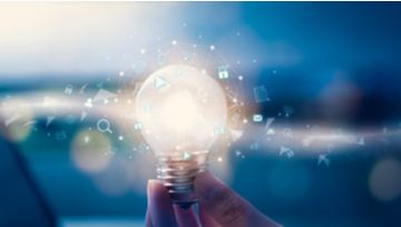 Hand holding futuristic light bulb