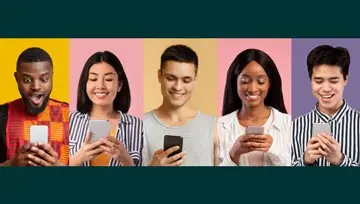 Diverse group of young people playing on their mobile phones