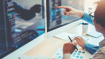 coding team at work looking at the computer screen